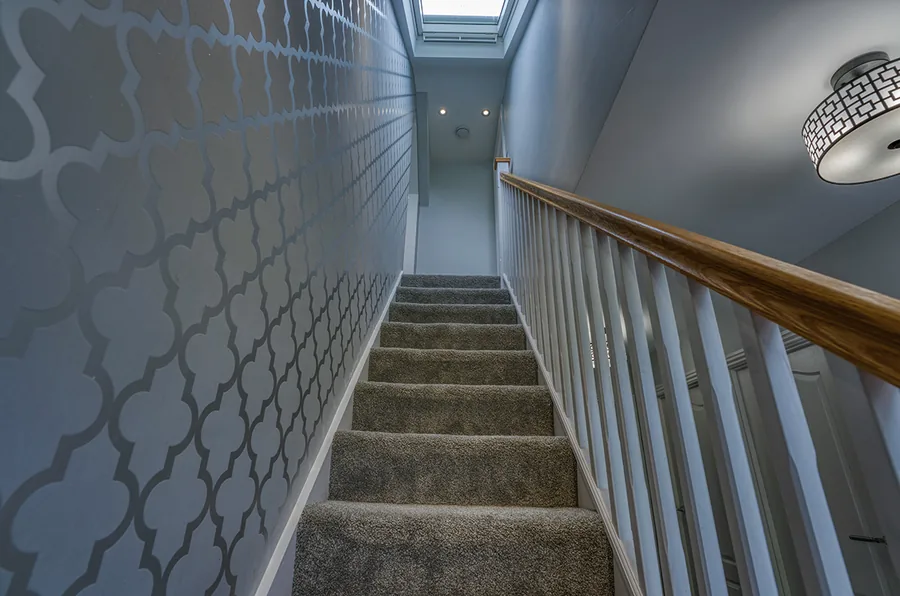 Loft conversion staircase with a rooflight above bringing in daylight