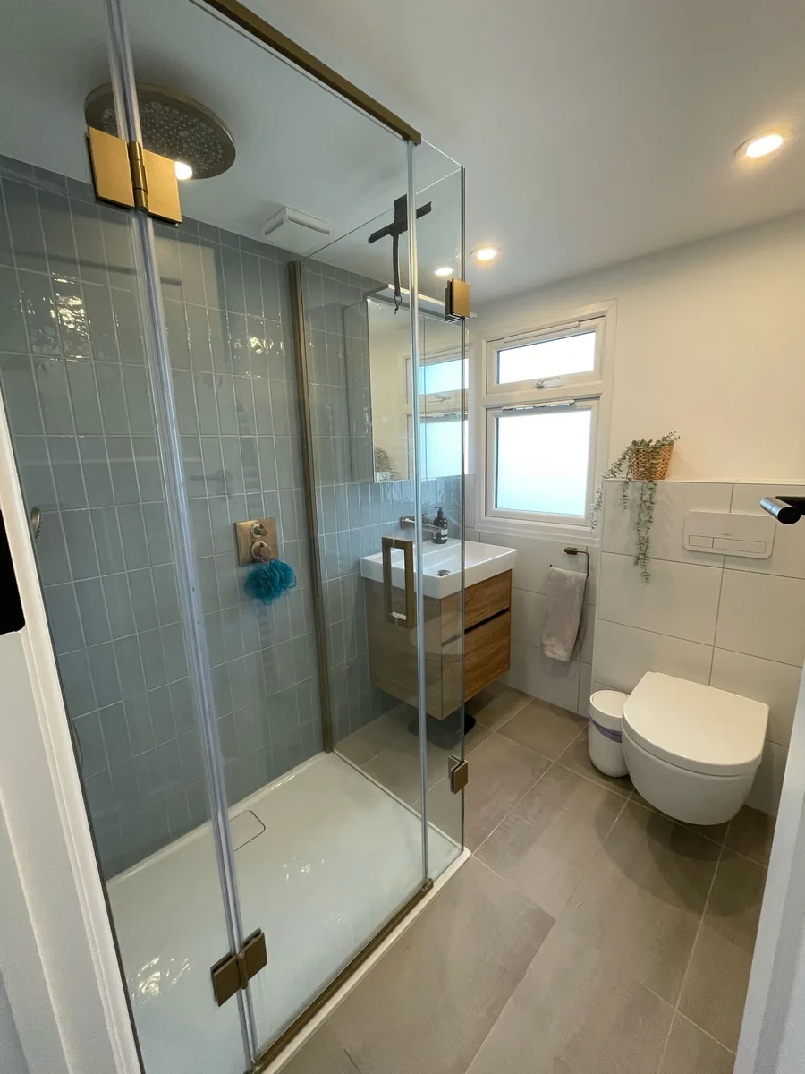 Loft conversion en-suite with a walk-in shower and tiled finish