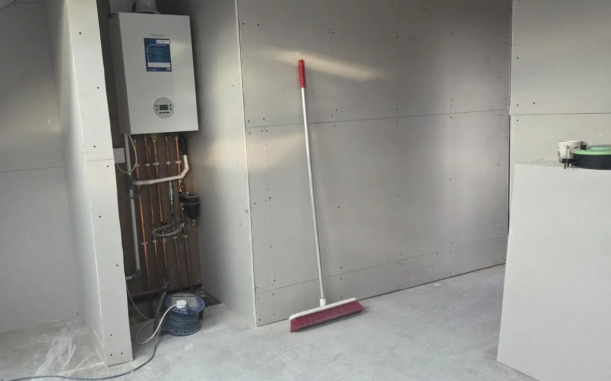 Plastered room in a Beckenham rear dormer loft conversion with the boiler cupboard built into the eaves