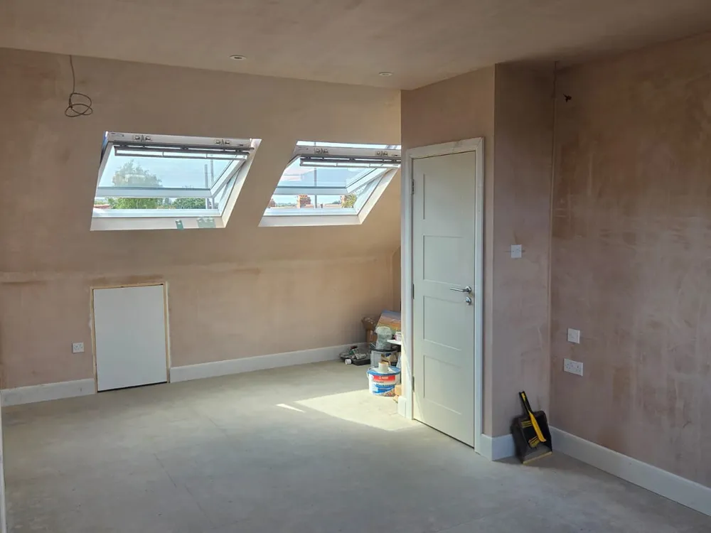 Beckenham loft conversion room with paired Velux roof windows after plastering