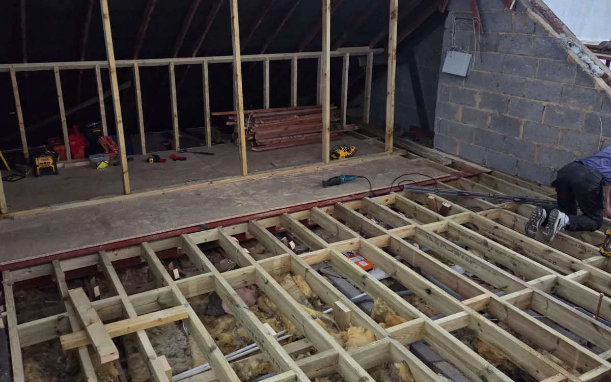 Box dormer being framed on a Penge loft conversion, with new floor joists and the roof opened up