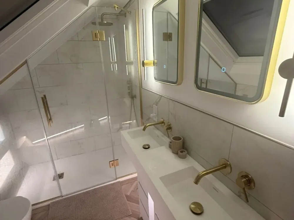 Loft ensuite with a walk-in shower under the slope and a double vanity basin, built by Loft Life