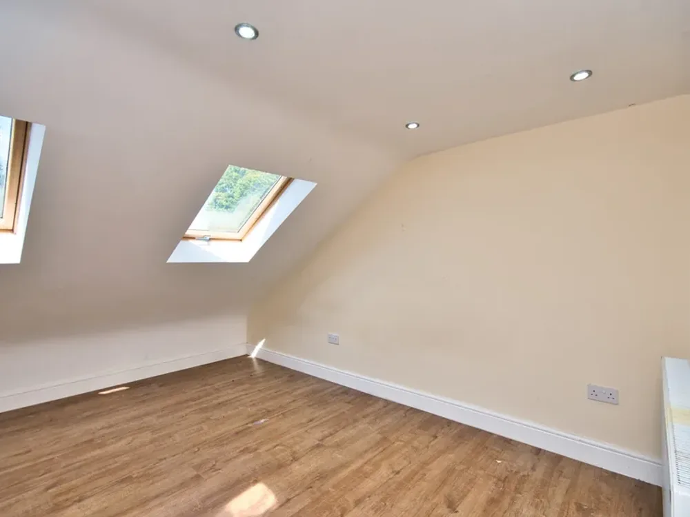 A Velux loft conversion with roof windows and a wood floor, well suited to a home office