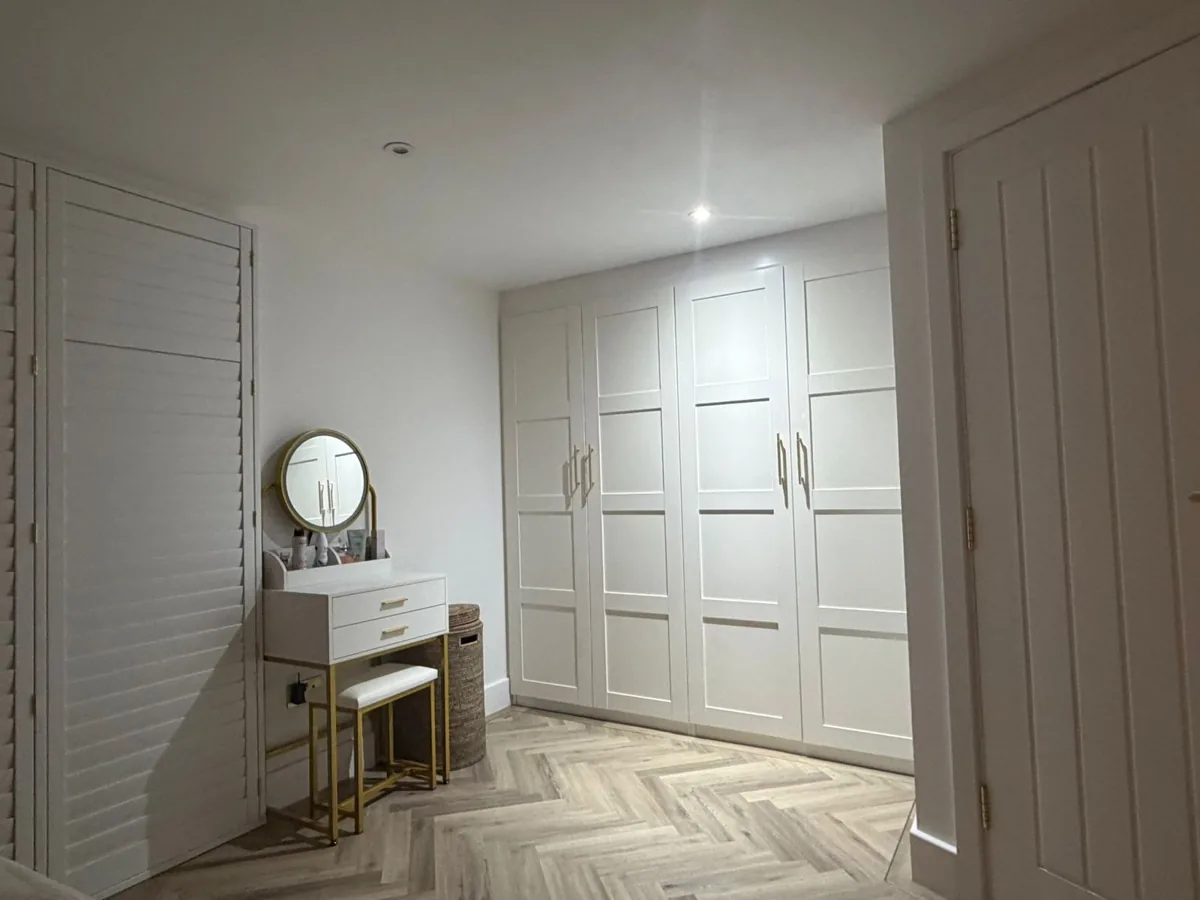 Dressing area with fitted wardrobes and a dressing table built into the loft