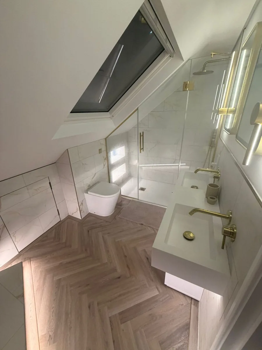 Loft en-suite with a freestanding bath, herringbone floor and brushed brass taps