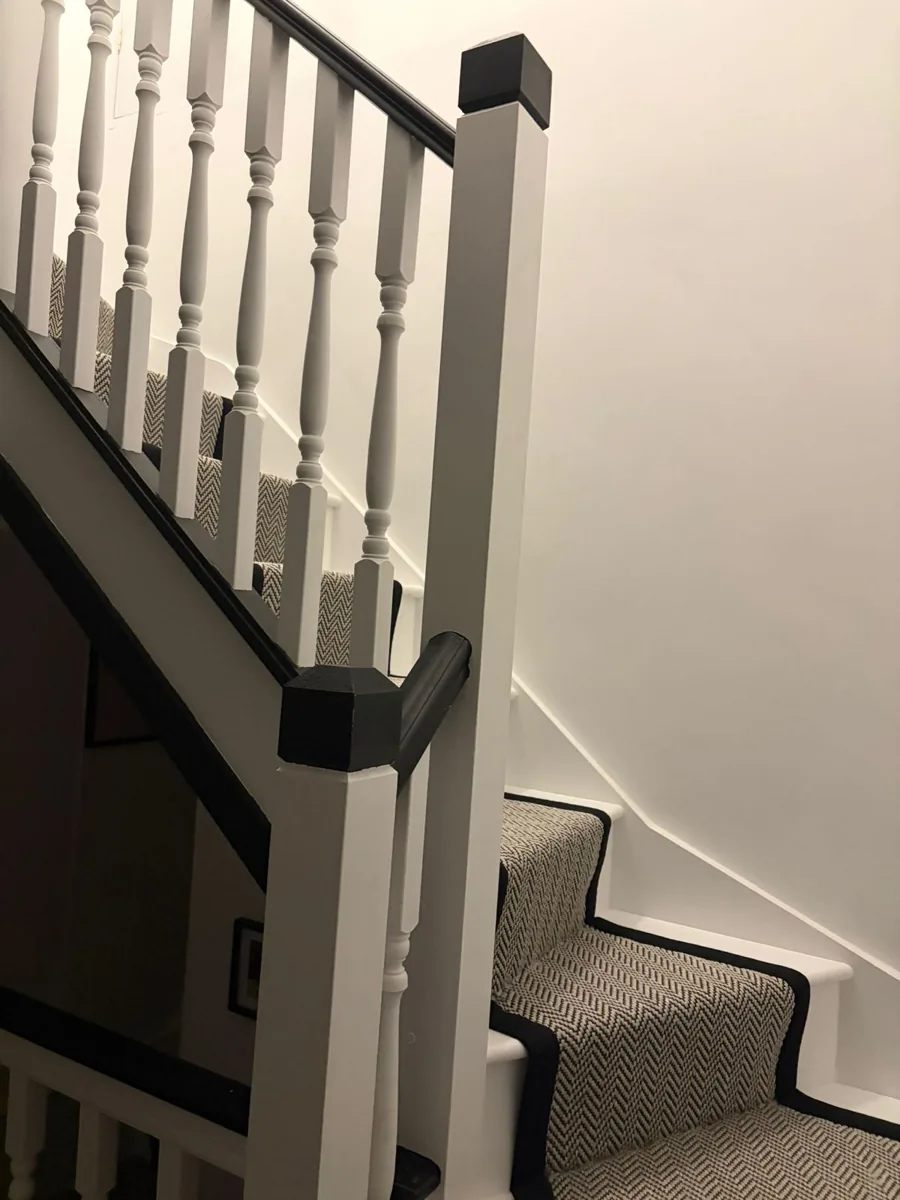 New loft staircase with white spindles and a grey carpet runner