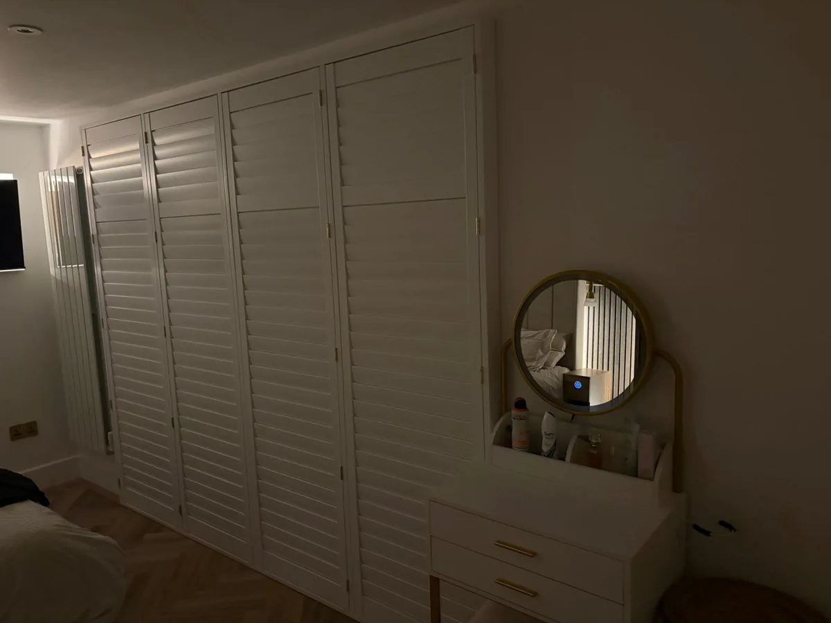 Fitted wardrobes with louvre doors built into the loft bedroom