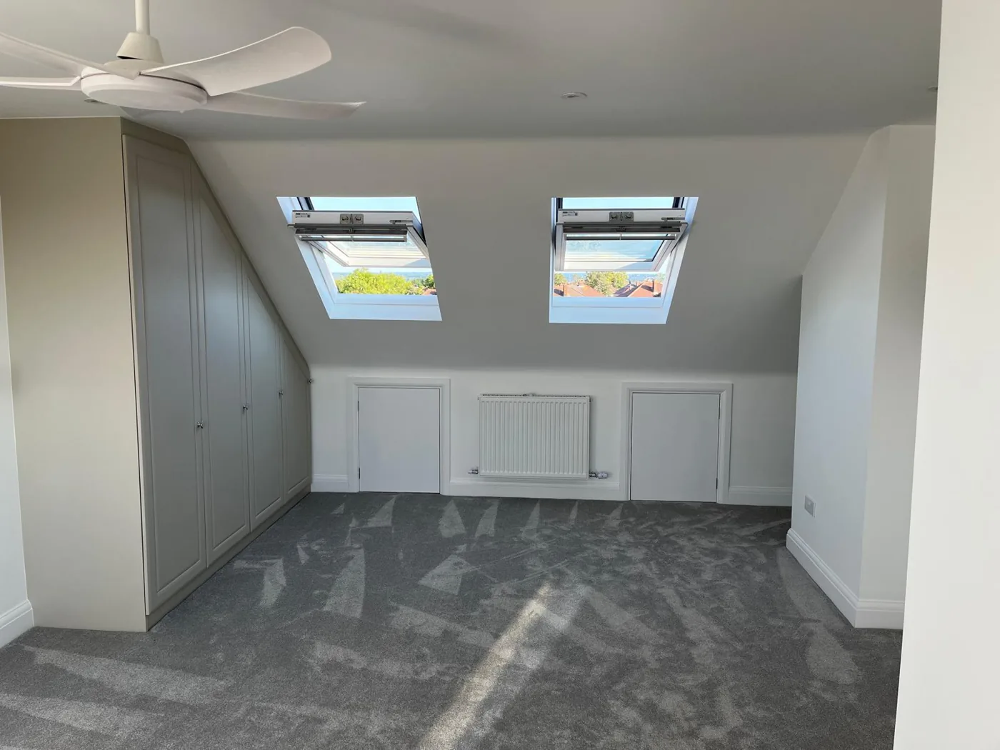Finished loft room with twin Velux roof windows and eaves storage