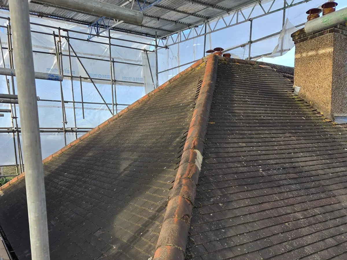 The original hipped roof of a London semi before work starts, seen from the scaffolding