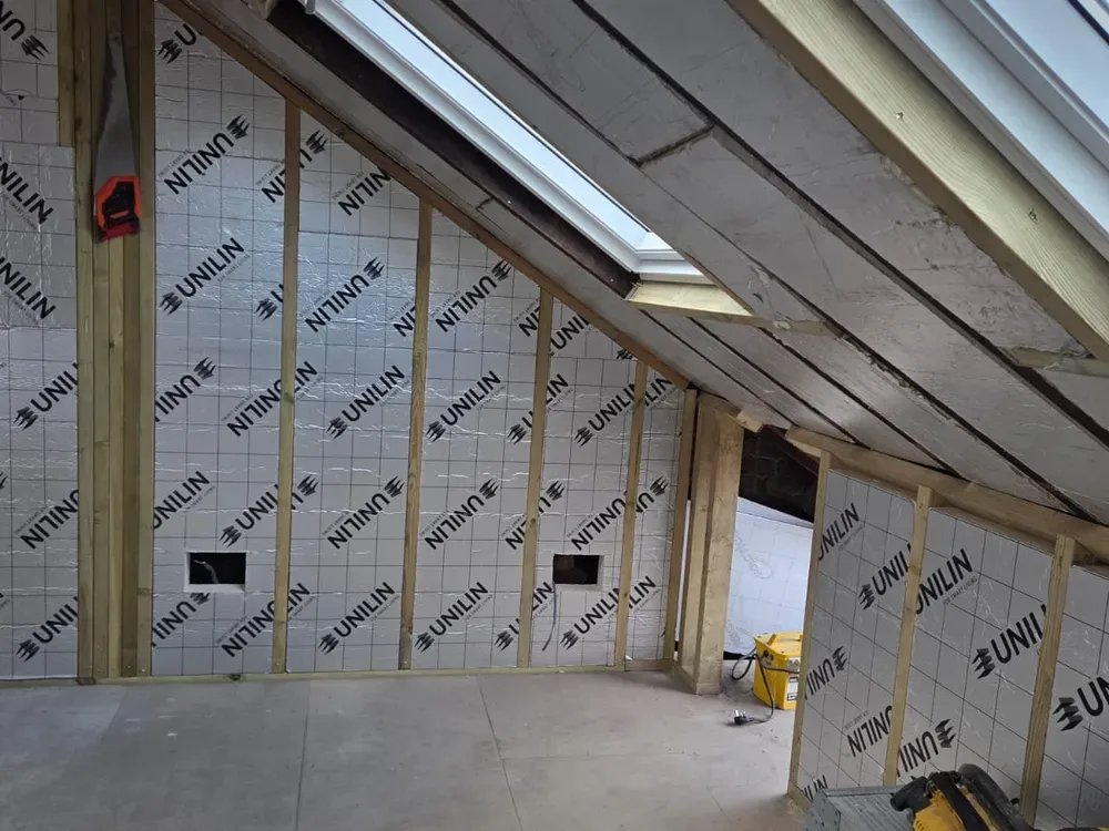 Roof rafters and insulation in a loft being converted from a trussed roof